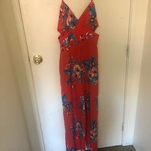 Bright red/pinkish jumpsuit with a tropical design